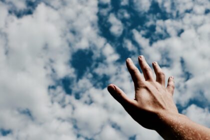 person hand reaching for the sky