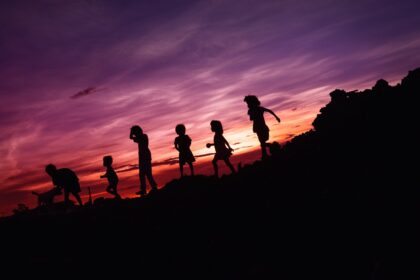 silhouette of children's running on hill