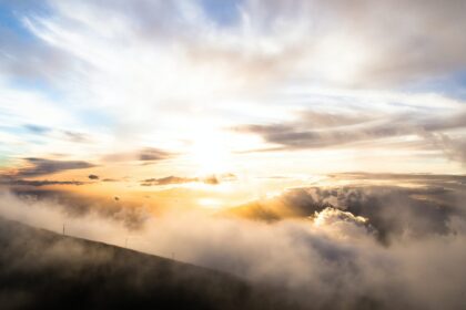 clouds above mountains during golden hour