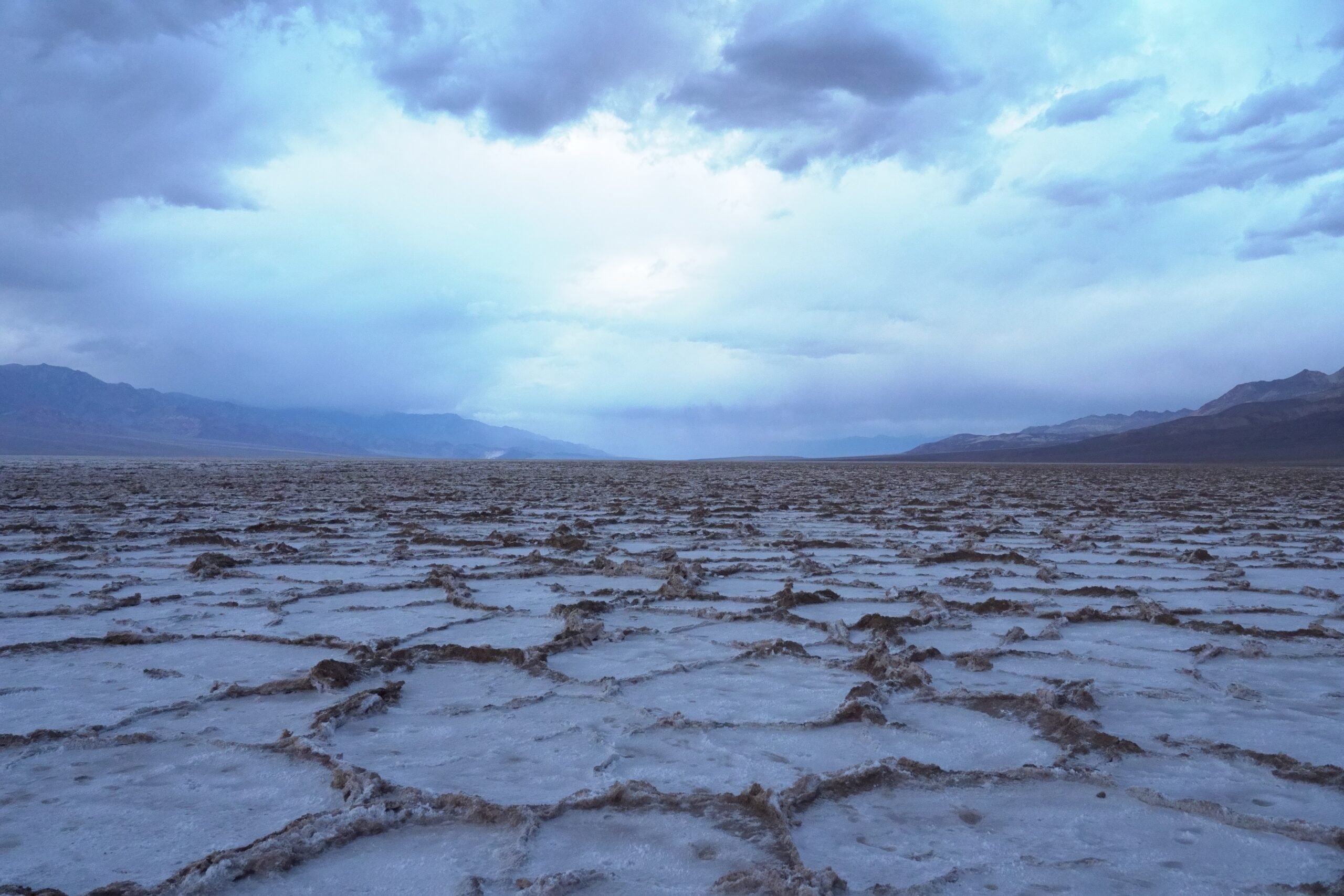 body of water under white clouds during daytime