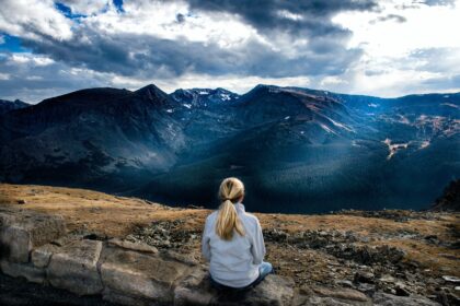 woman sitting on gray stone
