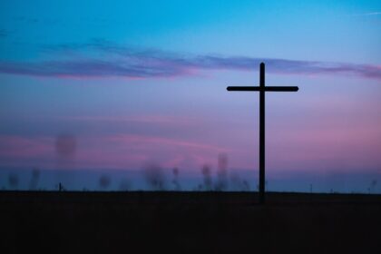 cross stand under purple and blue sky